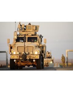 U.S. soldiers drive across the Kuwait border from Iraq
