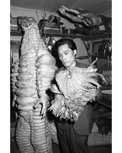 Monster maker Ryosaku Takayama checking Ragon monster's head, 1966