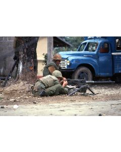 Two Marines load and ready their heavy machine gun in a Hue street, 1968